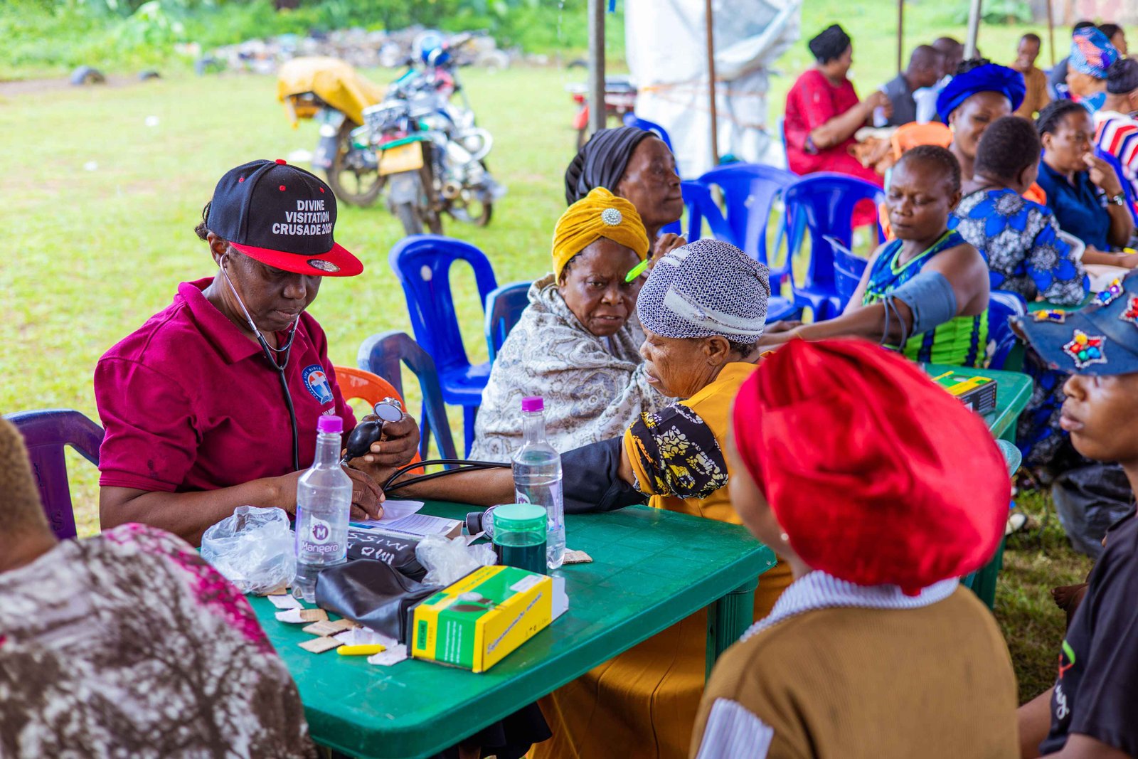 Christian medical mission outreach doctor checking blood pressure of an elderly patient